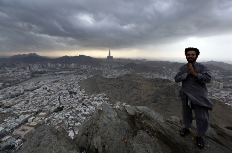 A Muslim pilgrim gestures at the top of Mount Noor, Oct. 21.