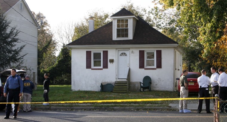 Investigators gather at a house on Clayton Avenue in Clayton N.J. on Oct. 23, after the discovery of a girl's body in a home's recycling bin.
