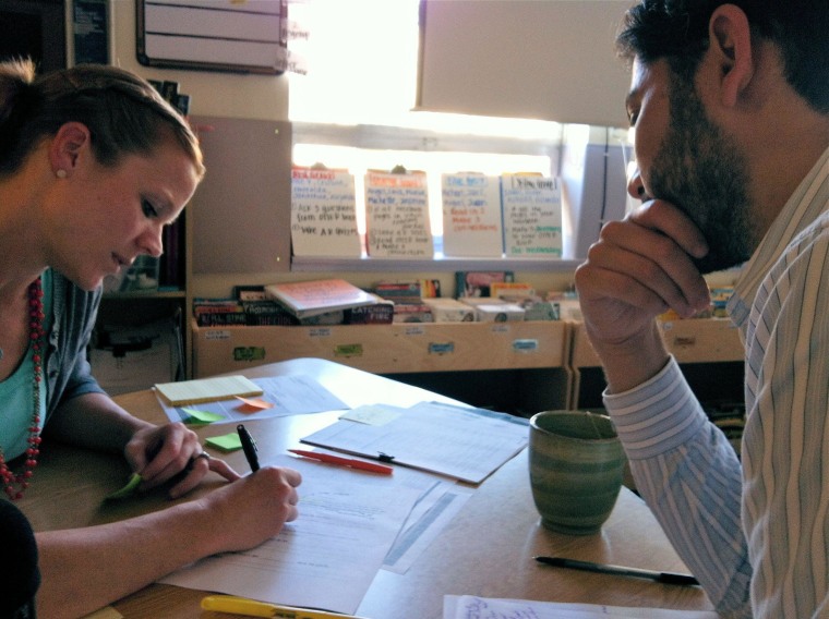 Amy Youngman, left, helps Danny Shapiro plan for his next week of teaching in the seventh- and eighth-grade classroom they share at ERES Academy in Oakland, California. Shaprio is a resident teacher-in-training and Youngman is his mentor.
