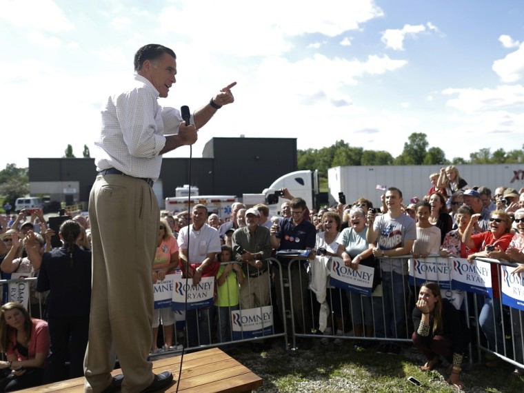 Republican presidential candidate Mitt Romney stands on a table as he addresses an overflow crowd as he campaigns at PR Machine Works in Mansfield, Ohio, Monday, Sept. 10, 2012.