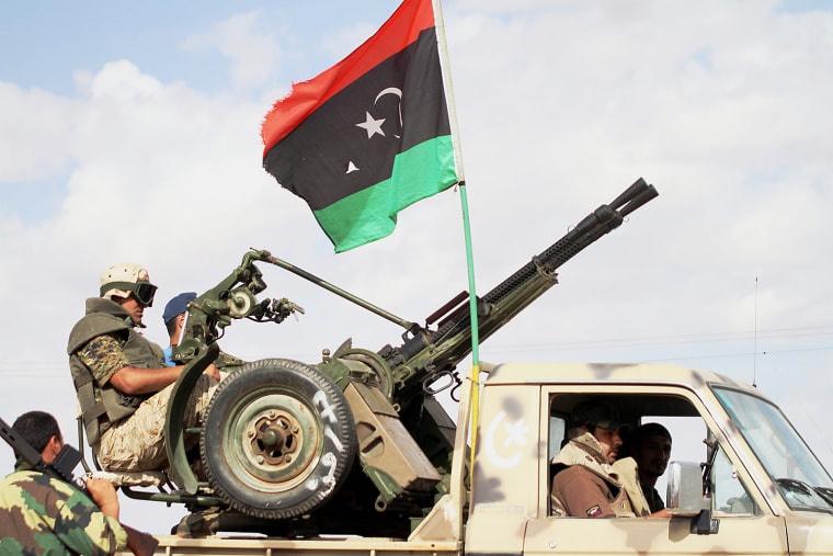 Libyan government fighters advance towards the town of Bani Walid, Libya, Oct. 23.