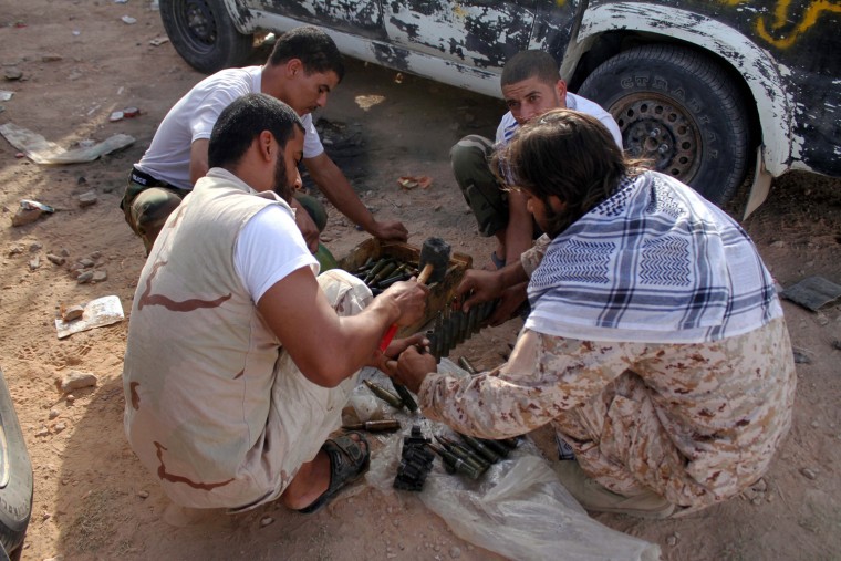 Libyan government fighters prepare ammunition before an advance towards the entrance to the town of Bani Walid, Libya, Oct. 23. Bani Walid is witnessing clashes between the army and some loyalists of the former Gaddafi regime. The Libyan army has seized most of the south-eastern town of Bani Walid, where it is pursuing a campaign against rogue militias, according to media reports from Oct. 22. The Libyan army launched a massive-scale attack on Bani Walid on Oct. 20 after a siege of more than two weeks.