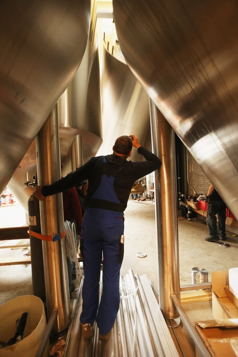 New York: Workers install a 25-foot tall fermenter at Brooklyn Brewery.