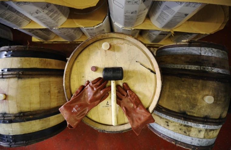London: A pair of gloves and a mallet rest on beer barrels at The Kernel microbrewery on October 17, 2012. Where once the big, multinational beer corporations accounted for the lion's share of brewery growth, now small, independent brewers are leading the way.