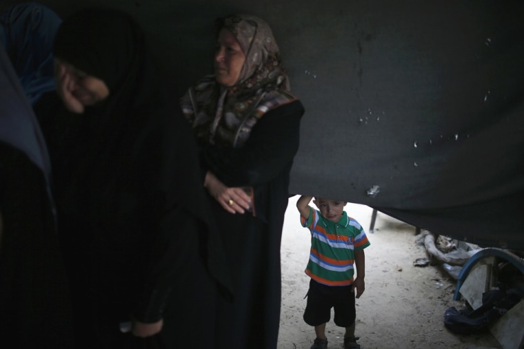 A Palestinian boy watches the funeral of Hamas gunman Ismail al-Tille in Beit Lahiya in the northern Gaza Strip on Oct. 24. Separate raids by Israel on Tuesday killed three members of the Islamist group, one of them al-Tille, in control of the coastal territory.