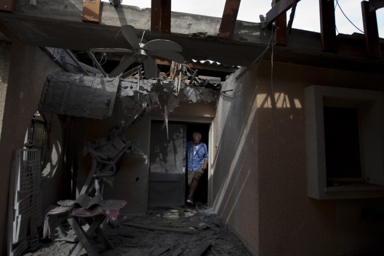 An Israeli man surveys the damage of his house after a rocket fired by Palestinian militants hit a community along the Israel Gaza Border, southern Israel, Oct. 24. Rockets and mortars from Gaza have pummeled southern Israel, drawing Israeli airstrikes that killed a Palestinian militant. The Israeli military said 60 rockets and mortars were fired by early morning Wednesday, following a volley the night before and that Israeli aircraft struck Gaza three times.