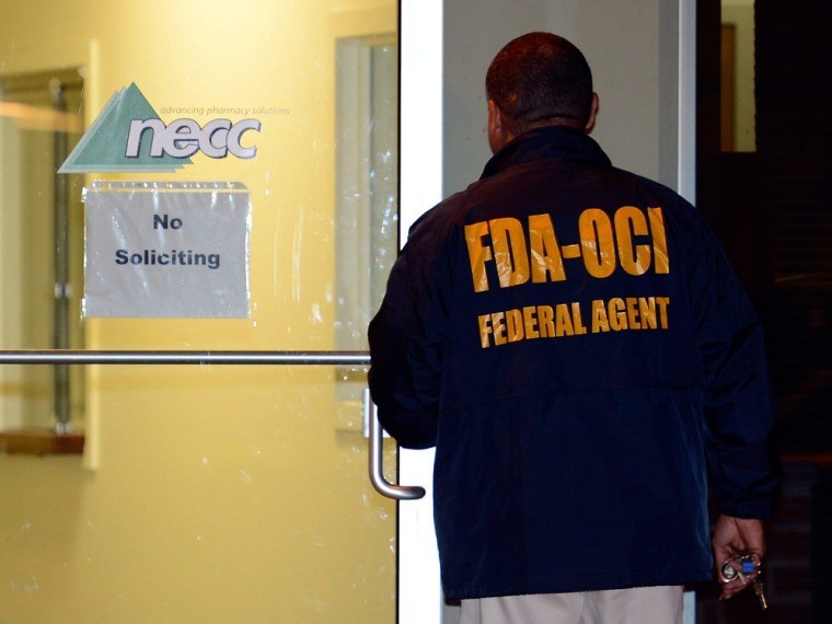 A Food and Drug Administration agent enters the New England Compounding Center, a pharmaceutical company in Framingham, Massachusetts, linked to an outbreak of fungal meningitis.