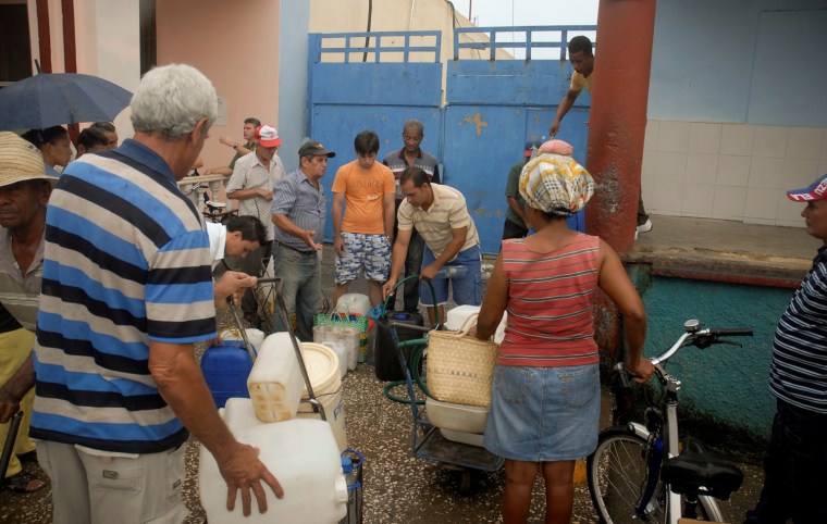 Citizens line up to be given water as they prepare for the arrival of Hurricane Sandy in Bayamo, Cuba, Oct. 24.