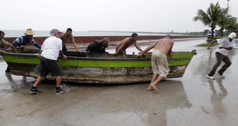 People remove a boat from the water ahead of the arrival of Hurricane Sandy in Manzanillo, Cuba, Oct. 24.