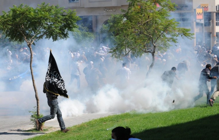 Protesters flee after security forces fired tear gas towards them outside the U.S. Embassy in Tunis, Tunisia, on Sept. 14.