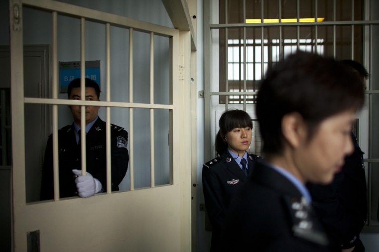 Police officers guard a hospital ward while visiting journalists are led on a government-organized tour at the Number Two Detention Center in Beijing on Oct. 25, 2012. Detention centers in China are primarily for people who have been detained by police on suspicion of committing a criminal offense and are awaiting trial.