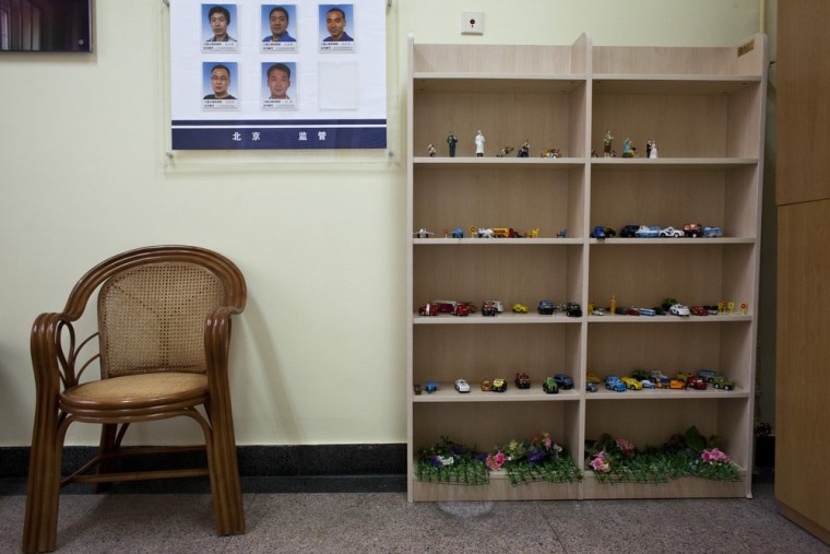 Toys, photos of psychiatrists, and a chair are arranged in a psychology consulting room at the Number One Detention Center.