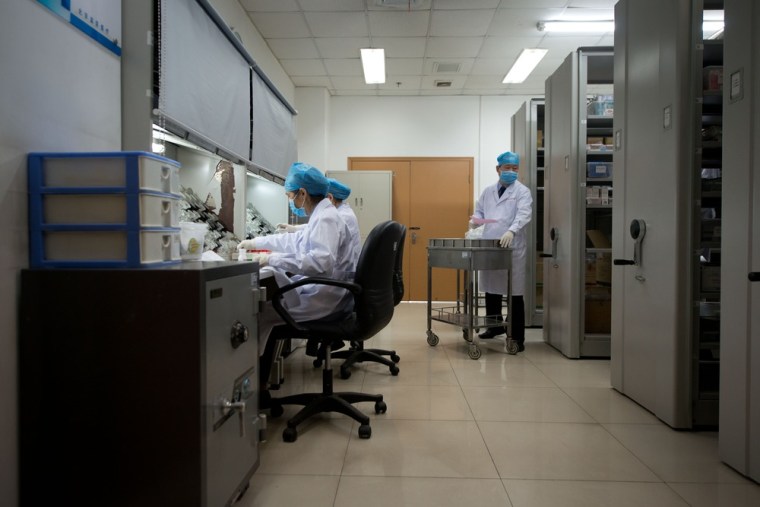 Pharmacists work inside a hospital wing at the No.1 Detention Center during a government guided tour.