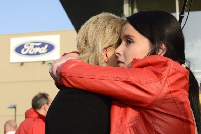 Ford workers comfort each other on Wednesday in front of the main entrance of Ford's Belgian assembly plant in Genk. Ford announced that it would close the Genk plant by the end of 2014. When sub-contractors are included, some 10,500 people depend on Ford Genk for work.AFP PHOTO / BELGA / DIRK WAEM - BELGIUM OUT -DIRK WAEM/AFP/Getty Images