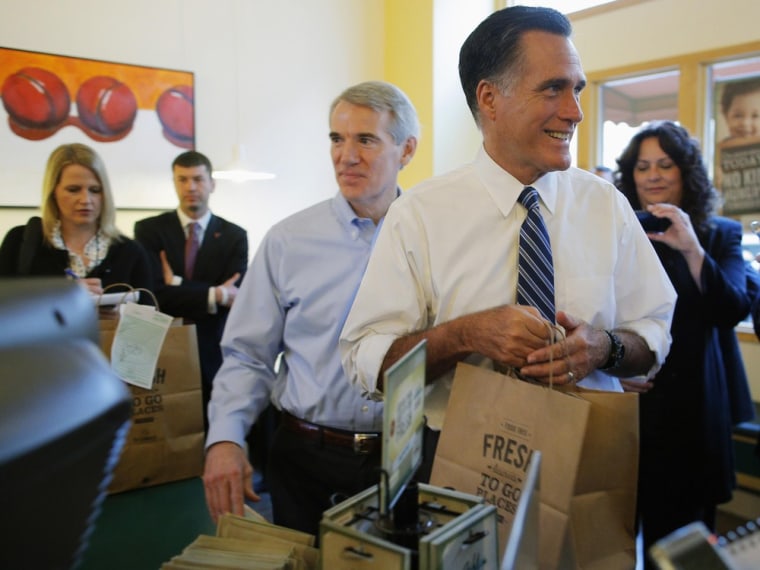 Republican presidential nominee Mitt Romney, accompanied by Sen. Rob Portman (R-OH) (C), picks up food at First Watch cafe in Cincinnati, Ohio October 25.