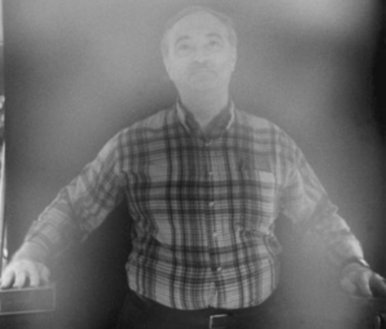 Paranormal investigator Joe Nickell appears to be surrounded by an aura in a photograph that was created to duplicate a spooky effect.