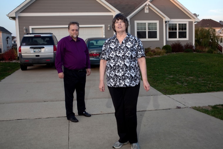 Robert and Kathy Miller, shown in front of their home, have struggled financially since Robert had heart surgery.