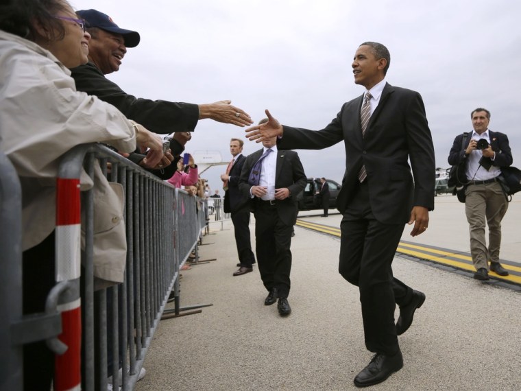 President Barack Obama greets supporters on the tarmac upon his arrival on Air Force One at O'Hare International Airport in Chicago, Thursday, Oct. 25, 2012.