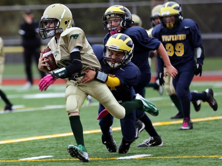 Hard knocks: 10-year-old Jayan White tackles an opponent.