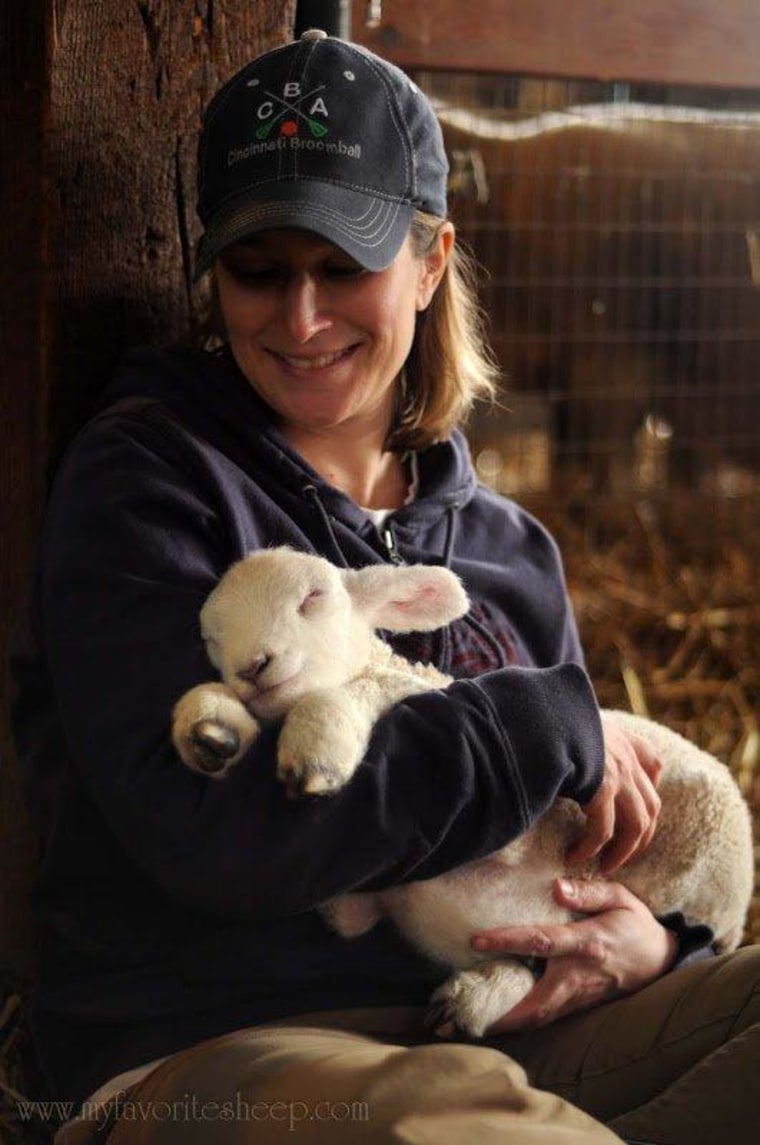 Debbie from Cincinnati, Ohio gives baby lamb Blossom a hug.
