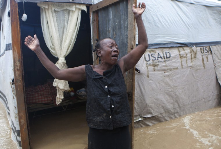 A woman cries out in front of her flooded house caused by heavy rains from Hurricane Sandy in Port-au-Prince, Haiti, on Oct. 25.