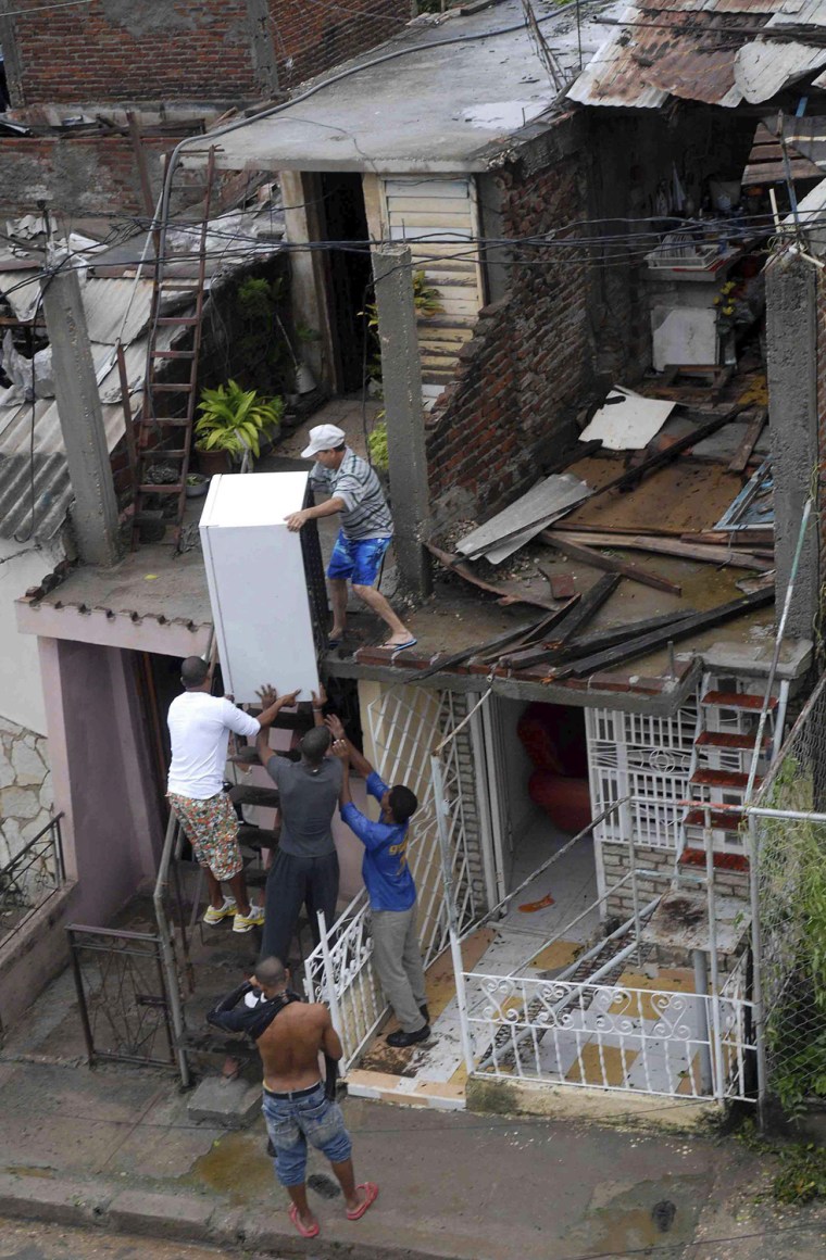 A resident salvages a refrigerator from his damaged house, with the help of other men, after Hurricane Sandy hit Santiago de Cuba on Oct. 25. Sandy hit southeastern Cuba early on Thursday with 105-mph winds that cut power and blew over trees across the city of Santiago de Cuba. Reports from the city of 500,000 people, about 470 miles southeast of Havana spoke of significant damage, with many homes damaged or destroyed.