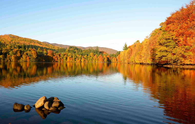 Autumn trees are reflected in the water of Faskally Loch near Pitlochry, Scotland on Oct. 26.