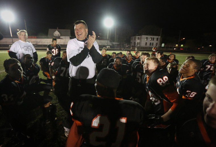 South High school football coach Lenny Sedlock celebrates after his team beat Edison on Oct. 12, 2012 in the first night game ever played at the school in Minneapolis.