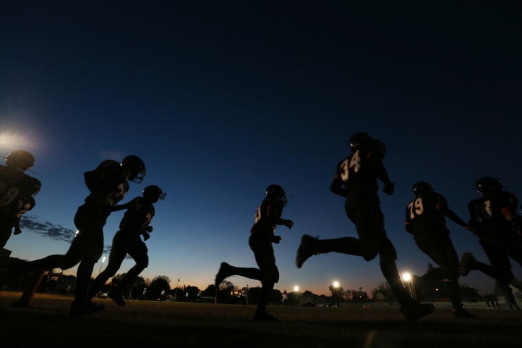Members of the South High school football team take the field Friday, Oct. 12, 2012 to face Edison High in the first ever game played under the lights at South High in Minneapolis.