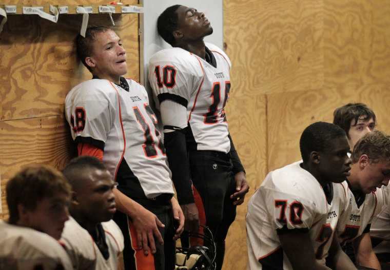 South High football players Anthony Hockett left and Jaylin Bynum and their team listen to half time instruction from their coach. South was down 28-0 to Eden Prairie on Sept. 28 at the half, and lost the game 42-0.
