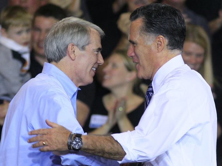 Republican presidential candidate, former Massachusetts Gov. Mitt Romney, right, shakes hands with Sen. Rob Portman, R-Ohio, after Portman introduced Romney at a campaign stop at Jet Machine, Thursday, Oct. 25, 2012, in Cincinnati.