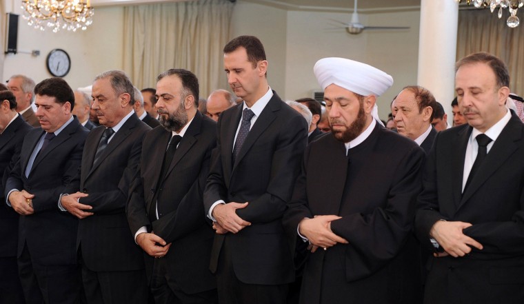 Syria's President Bashar al-Assad attends prayers for Eid al-Adha, at al-Afram Mosque in al-Muhajirin area in Damascus on Oct. 26, 2012, in this handout photograph released by Syria's national news agency SANA.