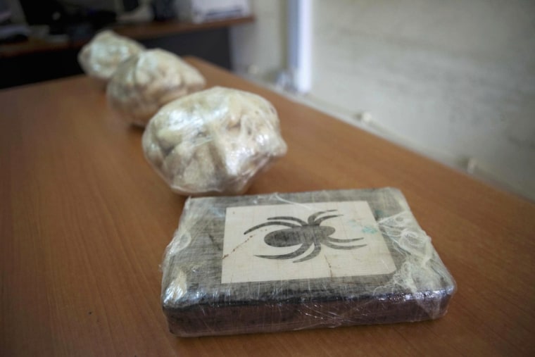 Cocaine seized by Guinea-Bissau's judicial police in the capital Bissau on March 21 is displayed for journalists.