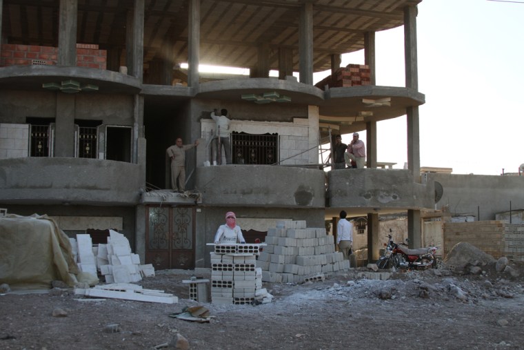 Bashir Said Mohammad surveys construction on a new home he began building in Derik, Syria, after the revolution started. He had been previously been denied permission because he is a Kurd.
