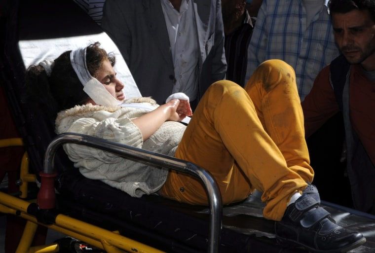 An injured girl on a stretcher after receiving first aid.