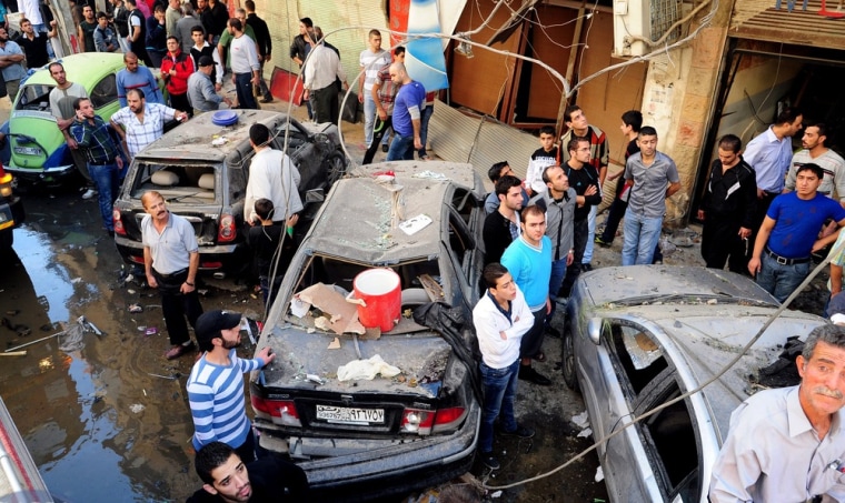 epa03451437 A handout picture released by Syrian Arab News Agency (SANA), shows gathering at the site where a car bomb exploded at Al Rawda area in Jaramana, southern Damascus, Syria, 29 October 2012. According to SANA, 11 persons were killed and 20 wounded after the explosion. EPA/SANA HANDOUT HANDOUT EDITORIAL USE ONLY/NO SALES