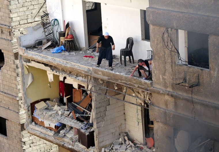 People in a damaged building at the site of the explosion.