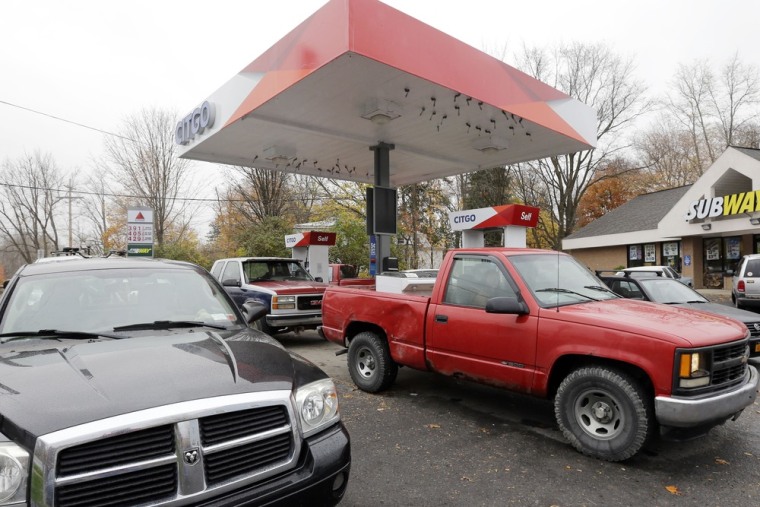 Motorists fill their vehicles and and gas cans in preparation for Hurricane Sandy Monday in Middleburgh, N.Y. Gas prices are likely to rise in the region until area refineries can safely reopen.