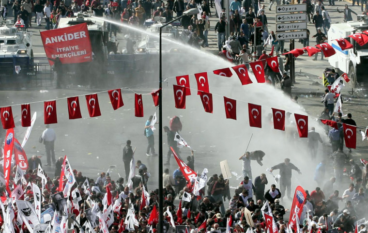Riot police use tear gas and water cannons to disperse a crowd as thousands of people march to the mausoleum of Ataturk to celebrate the country's Republic Day in Ankara, Oct. 29.