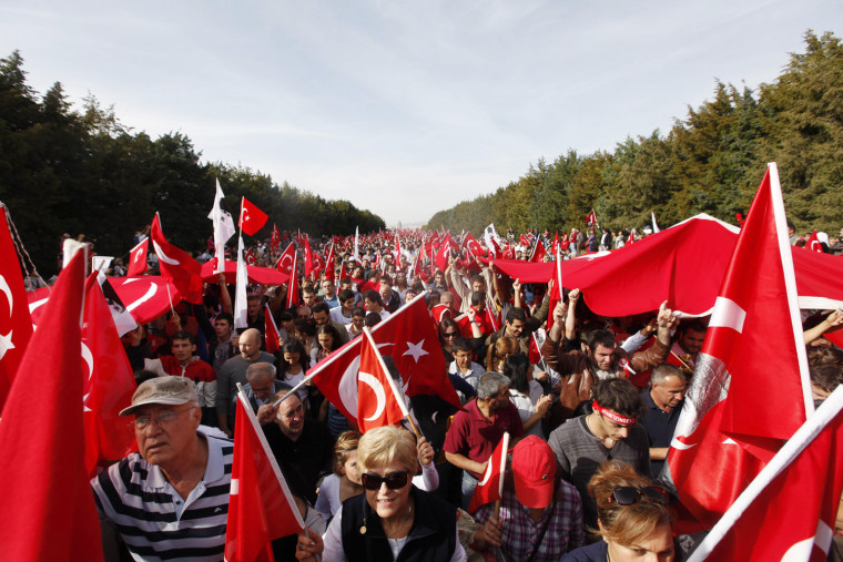 Demonstrators wave flags as they march to the Anitkabir, mausoleum of the founder of secular Turkey Mustafa Kemal Ataturk, in central Ankara, Oct. 29.