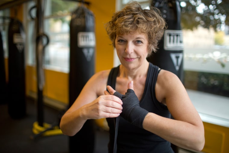 \"You take a hit to your femininity,\" says Diane Mapes, seen here wrapping her hands before working out at Axtion Club boxing gym in Seattle. \"But your hair comes back, strength comes back, and my boobs will come back eventually.\" Mapes had a double mastectomy in 2011.