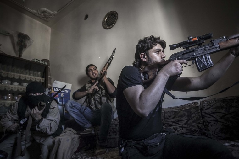 A rebel sniper aims at Syrian army positions in Aleppo's Jedida district on Oct. 29, 2012.