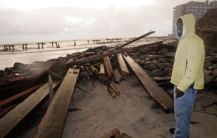 An Atlantic City resident surveys the damage done to a demolished section of the boardwalk on Tuesday morning.