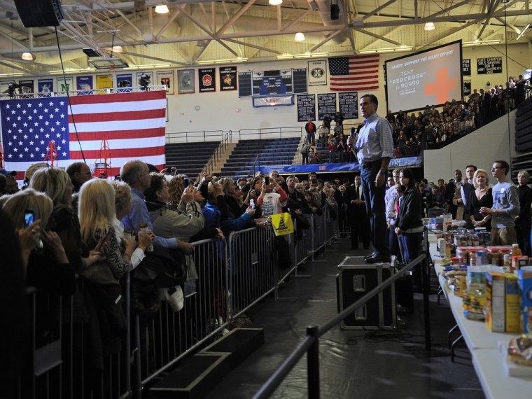 Republican Presidential candidate Mitt Romney talks to supporters calling for donations during a storm relief campaign event to help people who suffered from hurricane Sandy, in Kettering, Ohio, on Oct. 30, 2012.