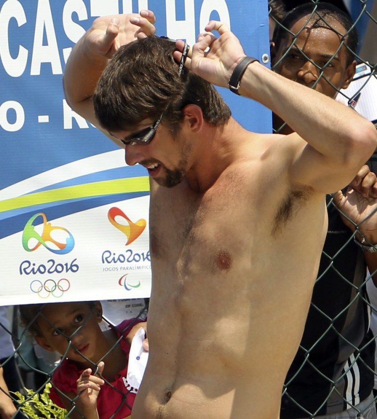 Olympic record gold medal winner U.S. swimmer Michael Phelps adjusts his googles during his visit to the sport complex of the Alemao favela in Rio de Janeiro, Brazil on Oct. 30.