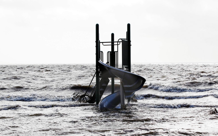 A playground apparatus stands surrounded by water pushed up by Hurricane Sandy in Bellport, New York, Oct. 30.