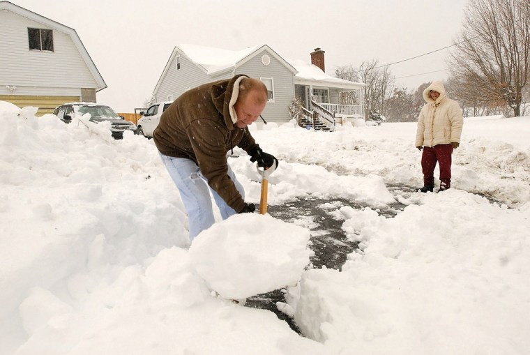 Joe and Linda Bays shovel snow in front of their home in Beckley, W.Va. on Oct. 30.