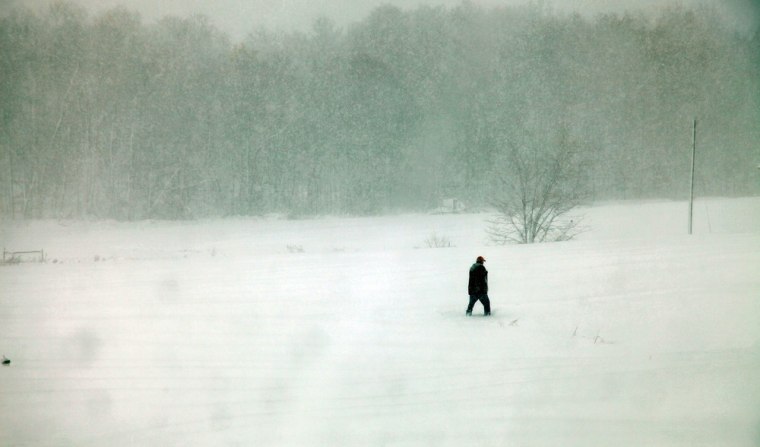 A person walks through snow on Oct. 30 in Belington, W.Va.