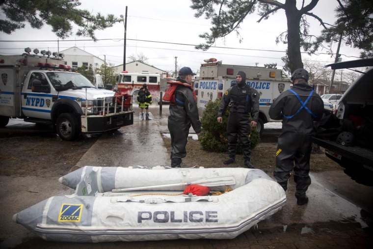 Police rescuers gear up to help people Oct. 30, in the Breezy Point neighborhood of the Queens borough of New York City.