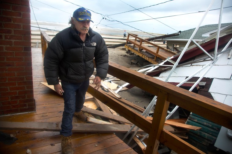 A home owner assesses the damage to his home Oct. 30, in the Breezy Point neighborhood.